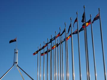 Aboriginal torres strait islander and australian flags outside the australian parliament house in july aboriginal torres strait islander and australian flags outside the australian parliament house in july